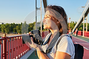 Mature woman photographer with camera taking photo picture