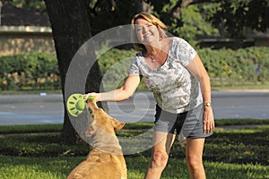 Mature woman playing with her dog.