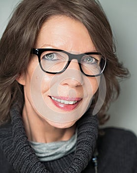 Mature woman portrait with black-rimmed glasses