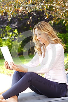 Mature woman portrait with digital tablet