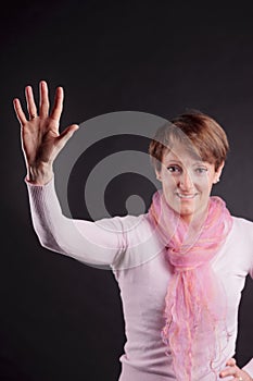 Mature woman with a raised hand