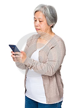 Mature woman read on cellphone