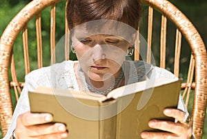 Mature woman reading book