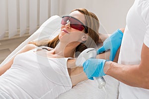 Woman Receiving Underarm Laser Hair Removal photo