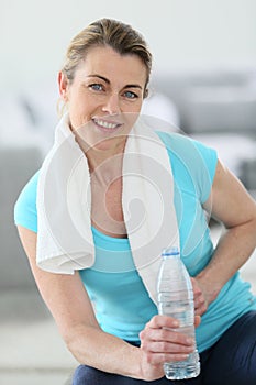 Mature woman relaxing after excercises at home