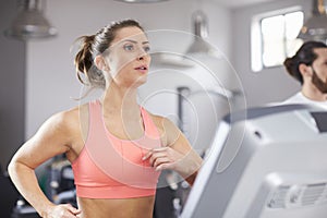 Mature Woman Running On Treadmill In Gym