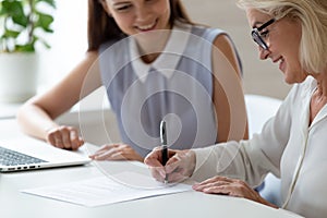 Mature woman satisfied client signing contract make deal affirming agreement