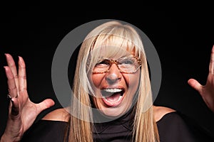Mature woman screaming hysterically close-up photo