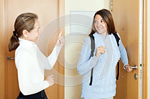 Mature woman sees off adult daughter at the door