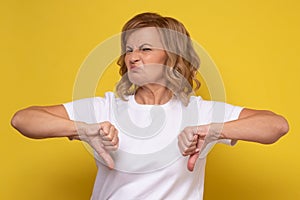 Mature woman showing thumbs down giving advice.