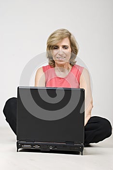 Mature woman sitting on floor