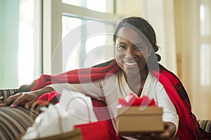 Mature woman sitting on her sofa at home.