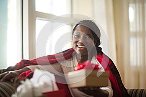 Mature woman sitting on her sofa at home.