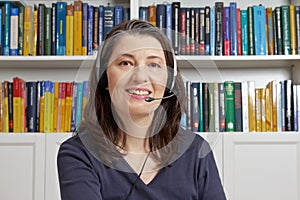 Mature woman smile headphones books
