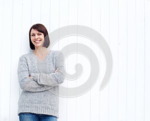 Mature woman smiling against white wall
