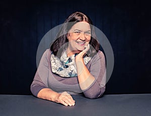 Mature Woman Smiling Laughing with hand on chin