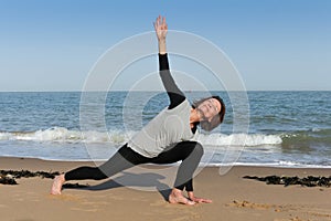 Mature woman sphinx yoga on the beach