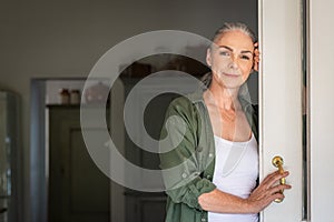Mature woman standing at door