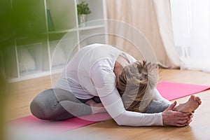 Mature woman stretching her body