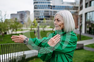 Mature woman stretching before run. Exercising after work for good mental health, physical health, relieving stress and