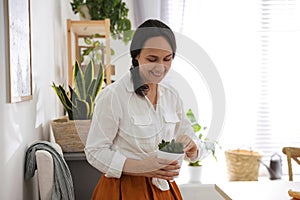 Mature woman with succulent plant. Engaging hobby