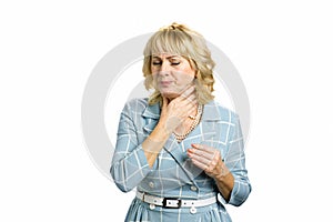 Mature woman suffering from sore throat.