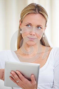 Mature woman, tablet and thinking in home, serious face and living room couch. Social media, technology and