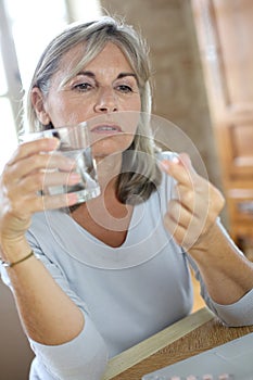 Mature woman taking drugs