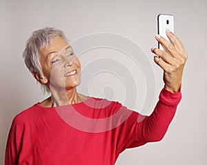 Mature woman taking a selfie with smartphone