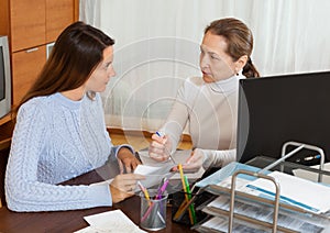 Mature woman talking with employee