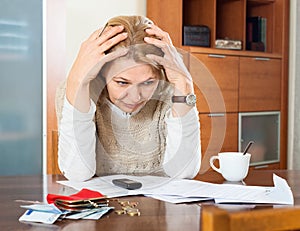 Mature woman thinking about family budget