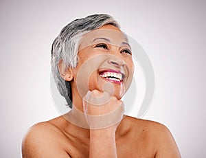 Mature woman, thinking and skincare in studio for aesthetic wellness, cosmetics or healthy facial collagen on white