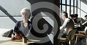 Mature woman, thinking and smartphone in modern office for break in communication, email or chat with coffee. Female