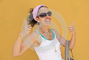 Mature woman Thumbs up Summer clothing Yellow wall