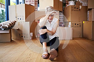 Mature woman, tired and boxes in new home, burnout and exhausted on floor, moving and sad for leaving. Rent, apartment