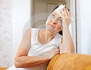 Mature woman uses handkerchief on head