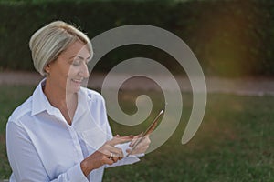 Mature woman using on tablet