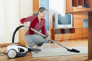 Mature woman with vacuum cleaner