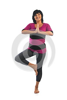 Mature woman in Vrikshasana yoga pose