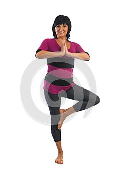 Mature woman in Vrikshasana yoga pose