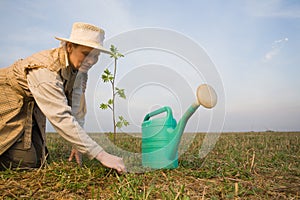 Mature woman with watering can