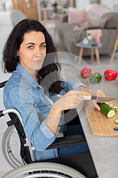 mature woman in wheelchair cooking