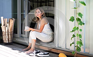 Mature woman working in home office in container house in backyard, resting.