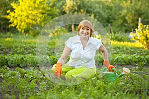 Mature woman working in vegetable garden