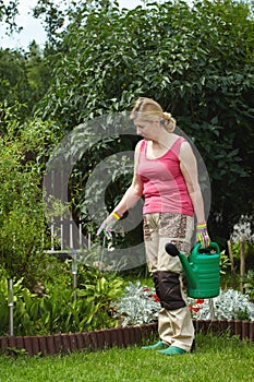 Mature woman works in her garden