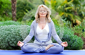 Mature woman in yoga position