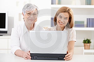 Mature woman and young daughter smiling happily photo
