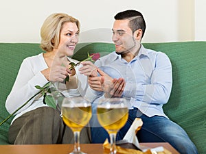 Mature woman with young guy indoors