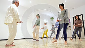 Mature women in a Qi gong class choreographing the exercises