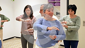 Mature women in a Qi gong class choreographing the exercises